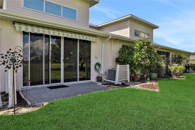 back of property featuring a yard