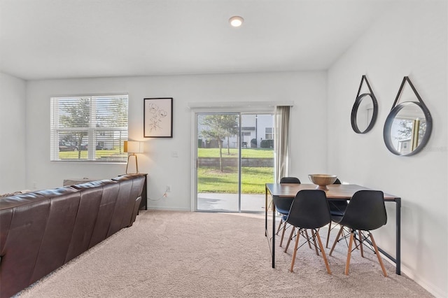 carpeted dining space with plenty of natural light