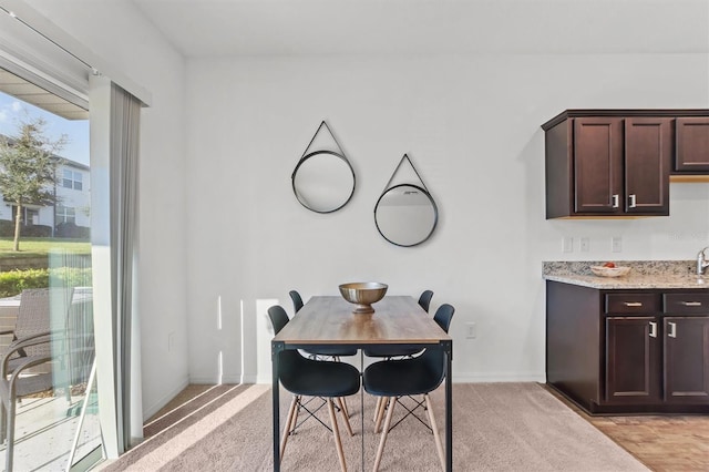 dining room with light carpet