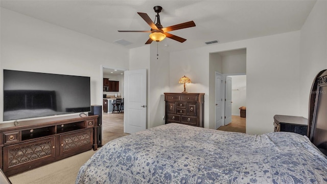 bedroom with ceiling fan and light carpet