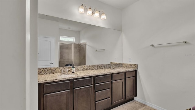 bathroom with tile patterned flooring, vanity, and a shower with door