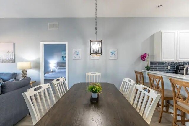 dining space featuring a chandelier and light hardwood / wood-style floors