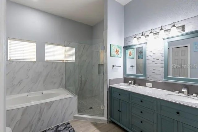 bathroom featuring vanity, separate shower and tub, and wood-type flooring