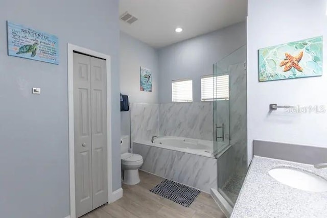 full bathroom with separate shower and tub, vanity, toilet, and hardwood / wood-style flooring