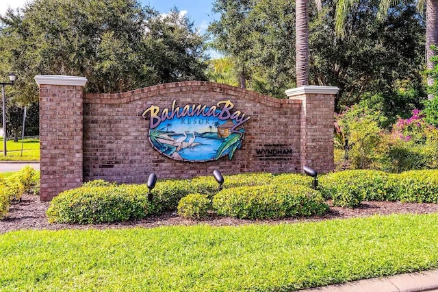 community sign featuring a lawn