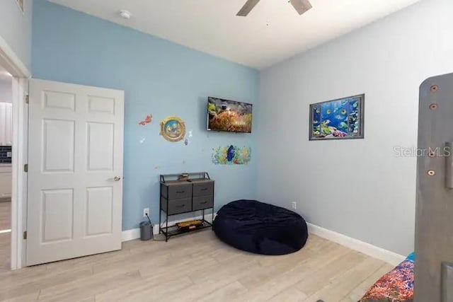 sitting room with light hardwood / wood-style floors and ceiling fan