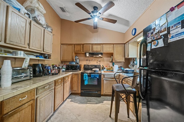 kitchen featuring ceiling fan, ventilation hood, vaulted ceiling, a textured ceiling, and black appliances