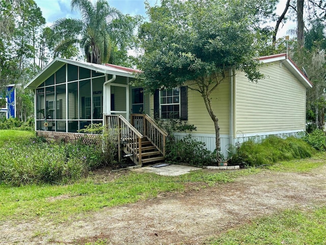 view of front of house with a sunroom