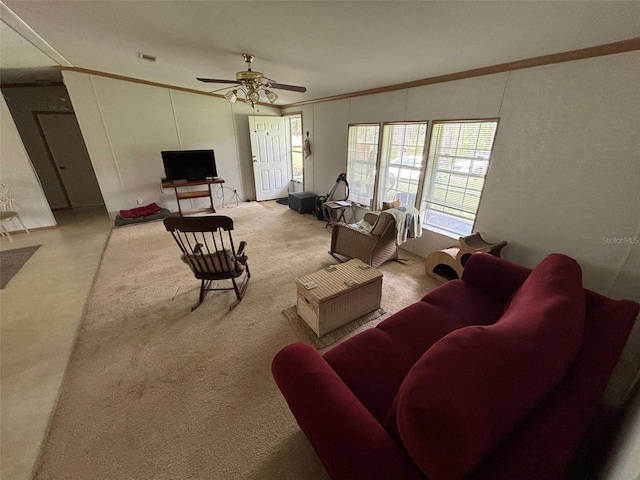 living room with ornamental molding, light colored carpet, lofted ceiling, and ceiling fan