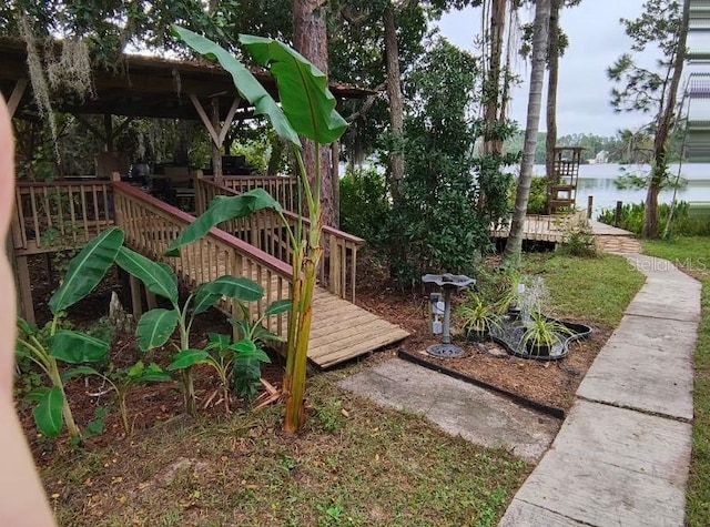 view of playground with a deck with water view