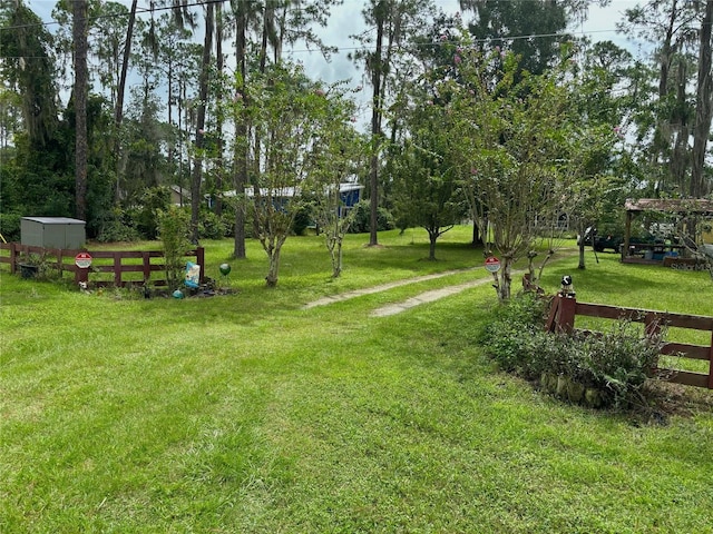 view of home's community with a yard and a shed