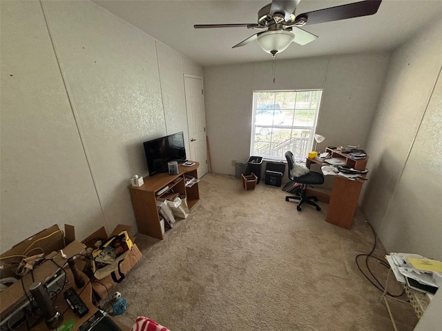 unfurnished office with ceiling fan and light colored carpet