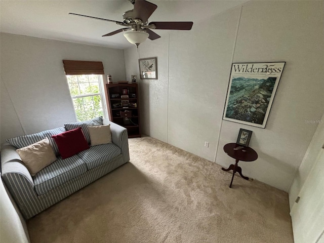 carpeted living room with ceiling fan