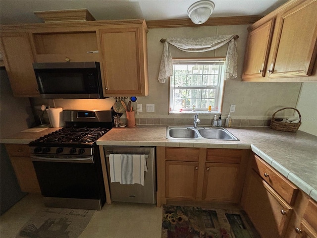 kitchen featuring tile countertops, sink, and appliances with stainless steel finishes