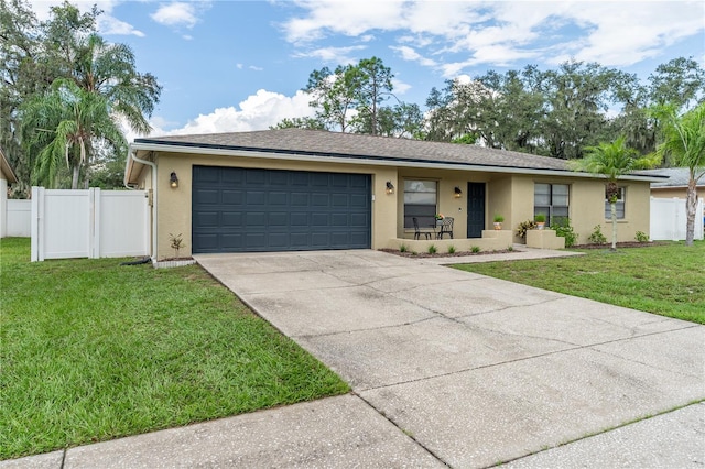 ranch-style home featuring a front lawn and a garage