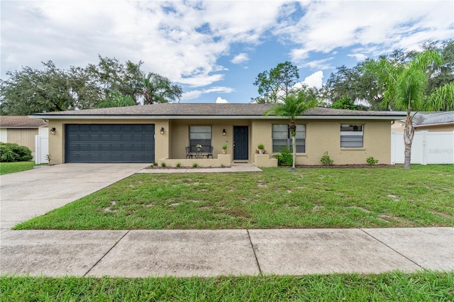 single story home featuring a front yard and a garage