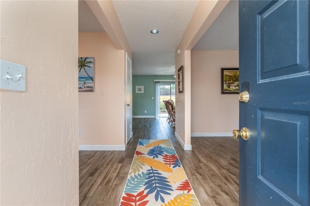 foyer entrance featuring a textured ceiling and hardwood / wood-style flooring