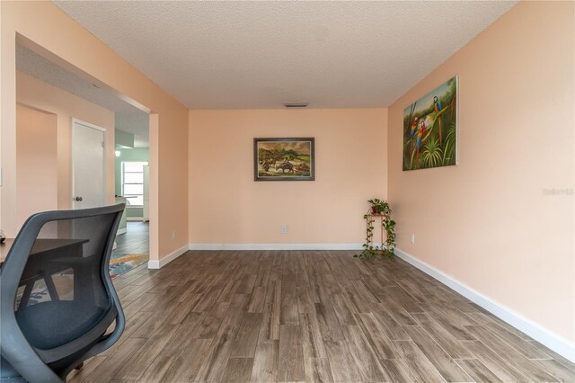 office space with hardwood / wood-style floors and a textured ceiling