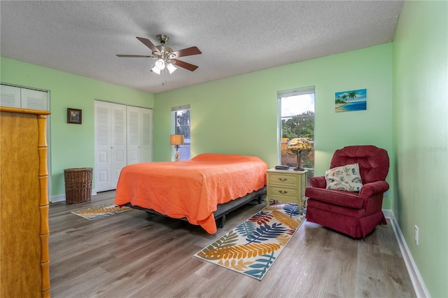 bedroom with hardwood / wood-style floors, a textured ceiling, and ceiling fan