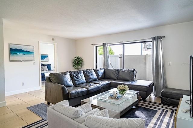 living room featuring a textured ceiling and light tile patterned flooring