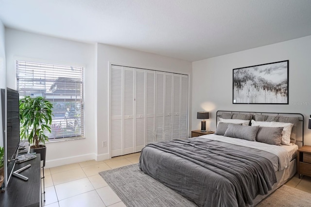 tiled bedroom featuring a closet