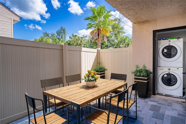 view of patio featuring stacked washer and clothes dryer