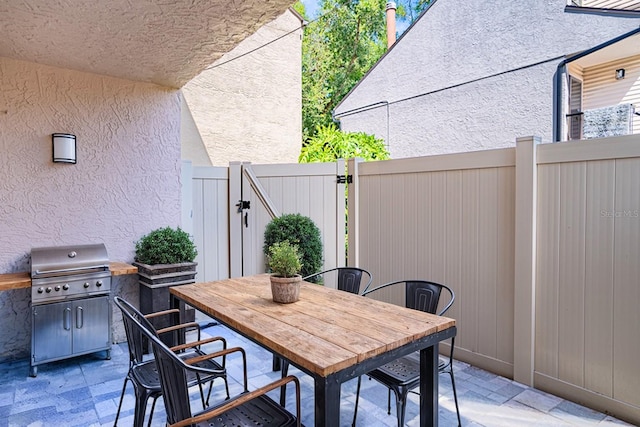 view of patio featuring a grill