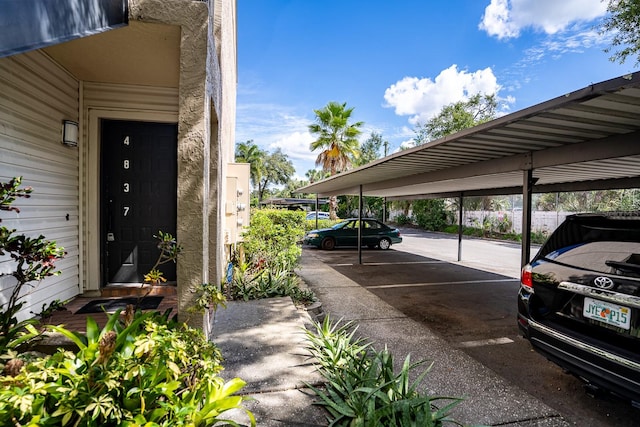 view of parking / parking lot featuring a carport