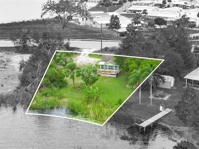 birds eye view of property with a water view