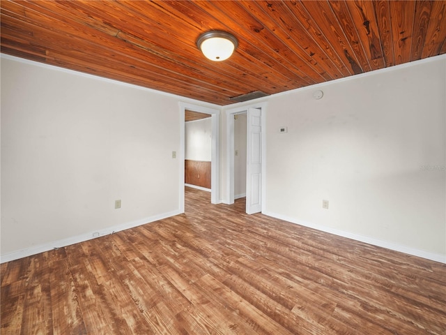 spare room featuring wood ceiling, ornamental molding, and light wood-type flooring