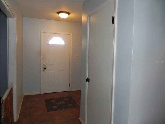 entryway featuring dark tile patterned floors