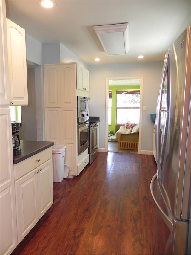 kitchen with white cabinets, dark countertops, recessed lighting, and stainless steel appliances