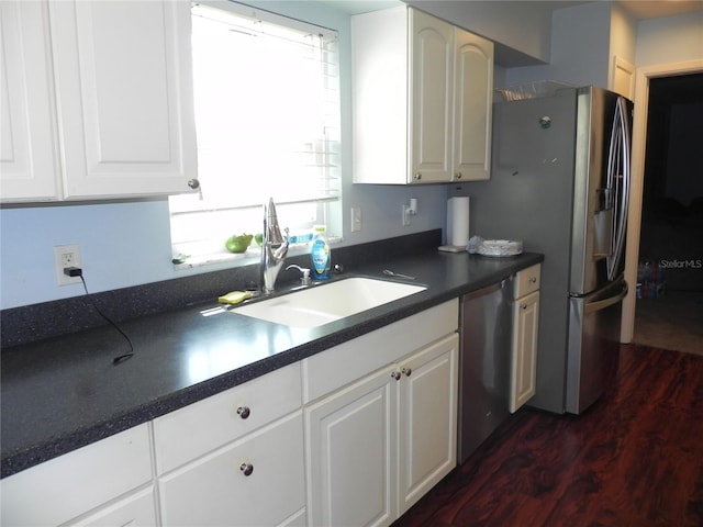 kitchen with sink, white cabinets, stainless steel appliances, and dark hardwood / wood-style floors