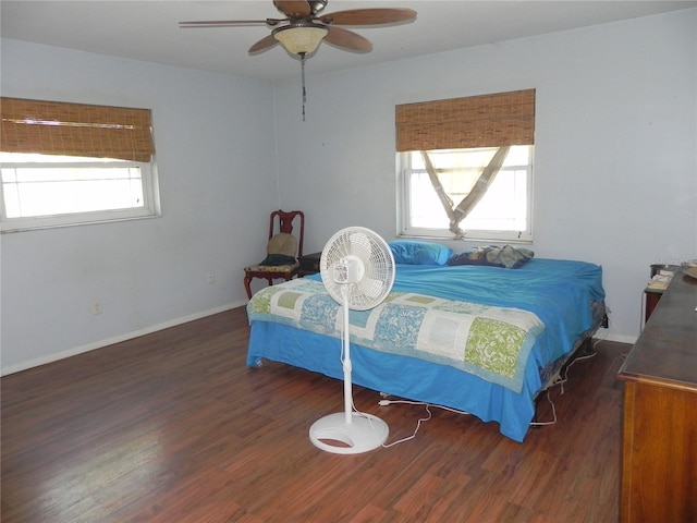 bedroom featuring multiple windows, ceiling fan, and dark wood-type flooring