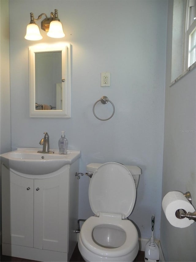 bathroom with toilet and vanity