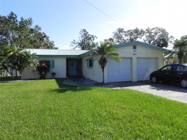 2201 W Pilaklakaha Ave, Auburndale, FL 33823 - ranch-style house with an attached garage, concrete driveway, a front yard, and metal roof