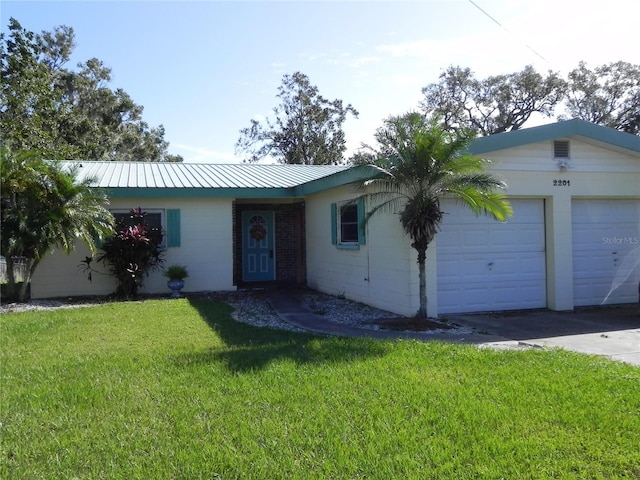 single story home with a front yard and a garage