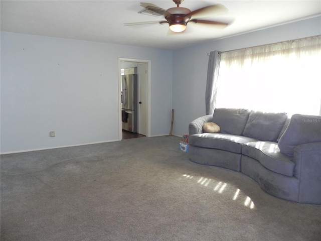 living room with ceiling fan and carpet