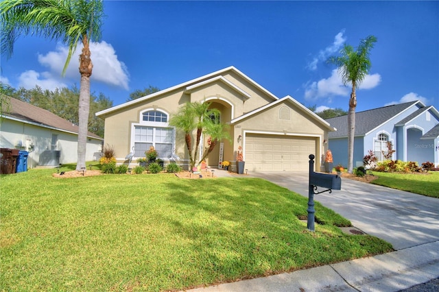 ranch-style house featuring a front lawn and a garage