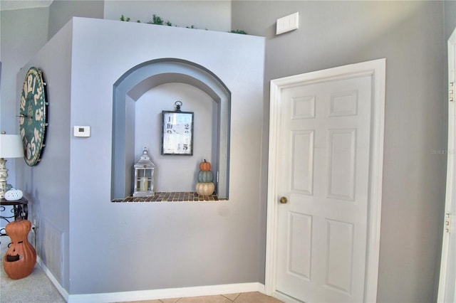 hallway with light tile patterned floors