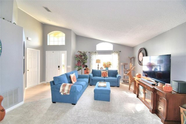 carpeted living room with high vaulted ceiling and a textured ceiling