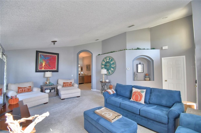 living room featuring carpet floors, a textured ceiling, and vaulted ceiling