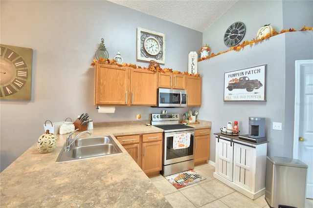 kitchen featuring appliances with stainless steel finishes, sink, light tile patterned flooring, a textured ceiling, and lofted ceiling