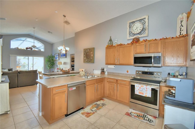 kitchen featuring hanging light fixtures, kitchen peninsula, stainless steel appliances, high vaulted ceiling, and ceiling fan with notable chandelier