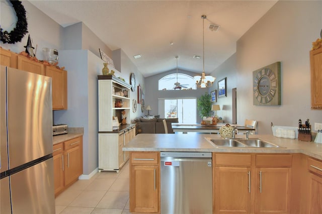 kitchen featuring sink, stainless steel appliances, vaulted ceiling, pendant lighting, and light tile patterned floors