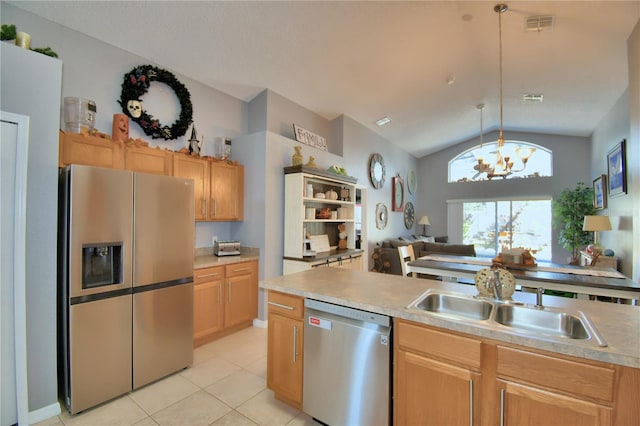 kitchen featuring lofted ceiling, hanging light fixtures, stainless steel appliances, sink, and a notable chandelier