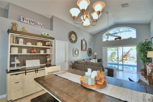 tiled dining area featuring a textured ceiling, vaulted ceiling, and ceiling fan with notable chandelier