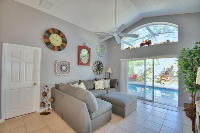 living room with light tile patterned floors, vaulted ceiling, and ceiling fan