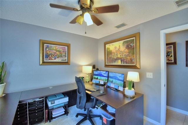 office area with a textured ceiling and ceiling fan