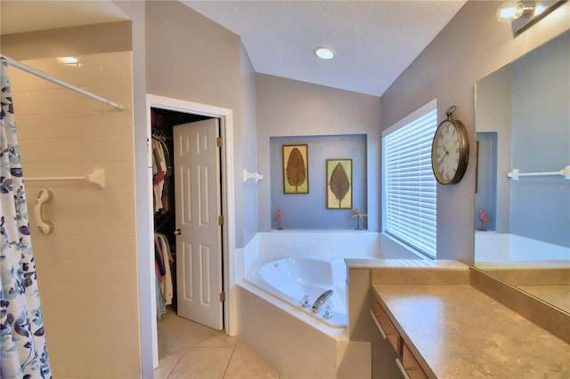 bathroom featuring a textured ceiling, vaulted ceiling, vanity, plus walk in shower, and tile patterned flooring